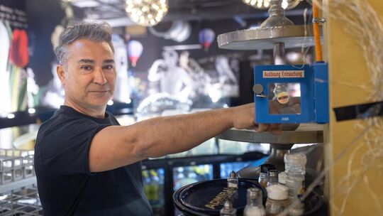 Sedat Aybulut demonstriert die Funktionstüchtigkeit der Rauchabzugsanlage. Hierfür drückt er den Knopf im Barbereich. Foto: Cars