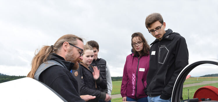 Ralf Athen von der Fliegergruppe Wolf Hirth (links) erklärt den Schülern das Cockpit des Segelflugzeugs.Foto: Tashi Dolma Hinz