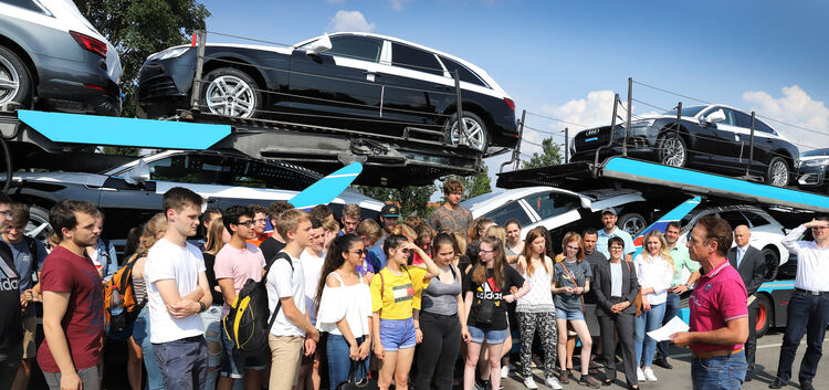 Fuhrparkleiter Dietmar Fuchs zeigt deutschen und amerikanischen Schülern einen voll beladenen Auto-Transporter.Foto: Jean-Luc Ja