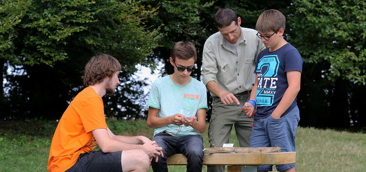 Robin (links), Felix (Zweiter von links), Jonas (rechts) und acht weitere Schüler erfahren von Martin Gienger, worauf es bei der