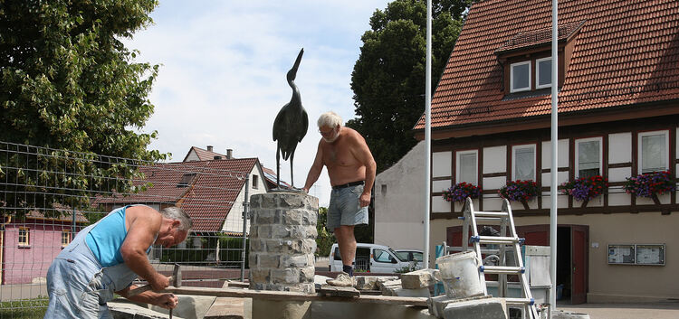 Auch von brütender Hitze lassen sich Willi Schindler (links) und Walter Richter bei der Sanierung des Storchenbrunnens in der Oh