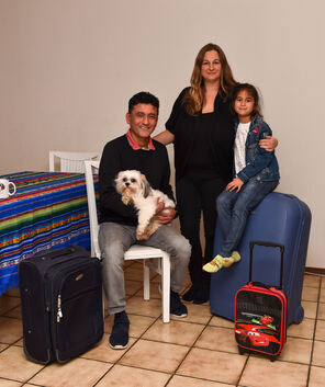 Auf gepackten Koffern sitzt Familie Villamar Ruiz. Foto: Markus Brändli