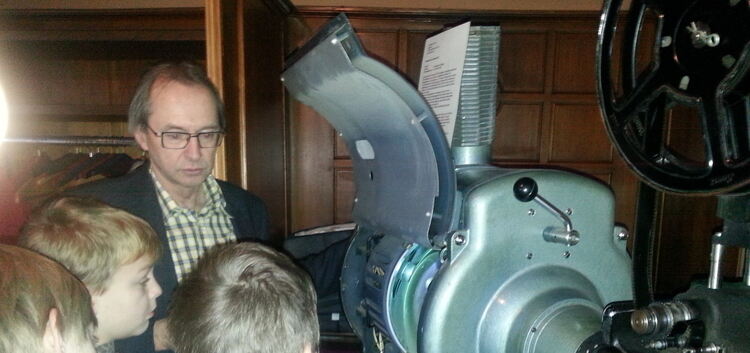 Eberhard Frech zeigt den Bissinger Viertklässlern den riesigen alten Filmprojektor.Foto: pr